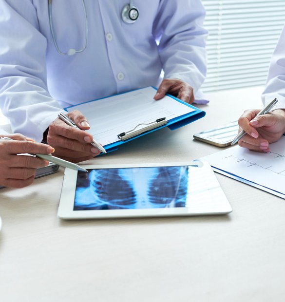 three-cropped-doctors-analyzing-chest-x-ray-digital-pad2